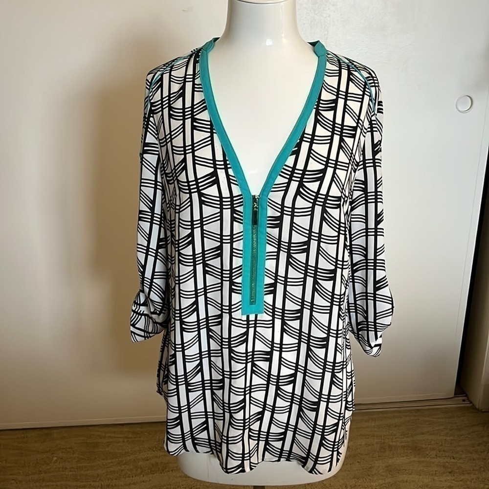 Bebe Printed Top with zipper accents.